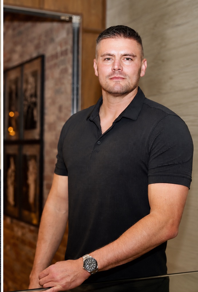 Austin Haag standing in an interior setting